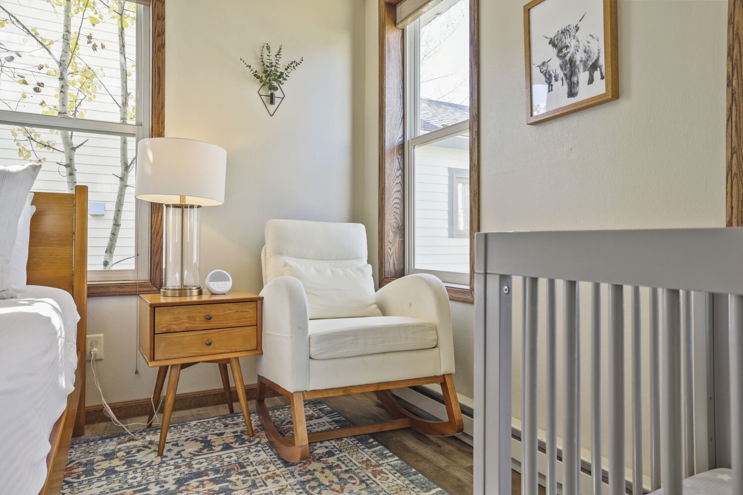 Settle into your cozy corner where a plush rocking chair invites peaceful moments. Bright windows flood the space with natural light, creating the perfect retreat for relaxation.
