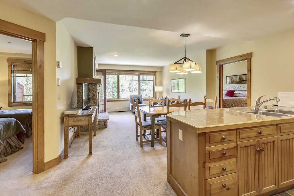 Your spacious suite offers a fully-equipped kitchen, cozy dining area, and living space with fireplace, all flowing seamlessly together.