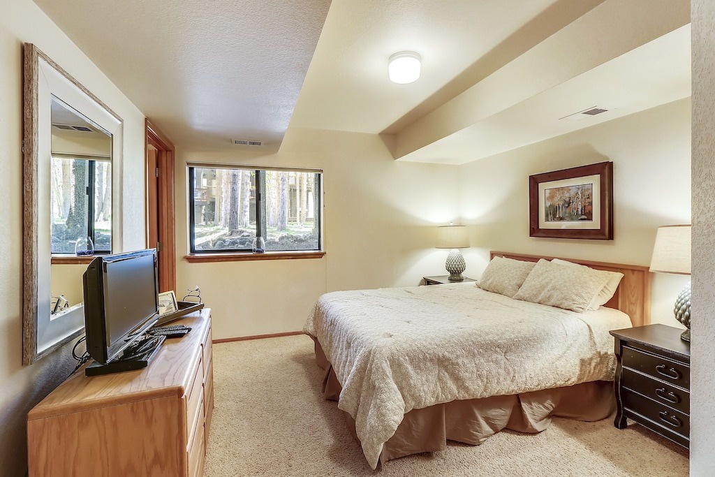 Relax in your private sanctuary with serene forest views, plush bedding, and rustic wood touches creating a perfect mountain retreat.