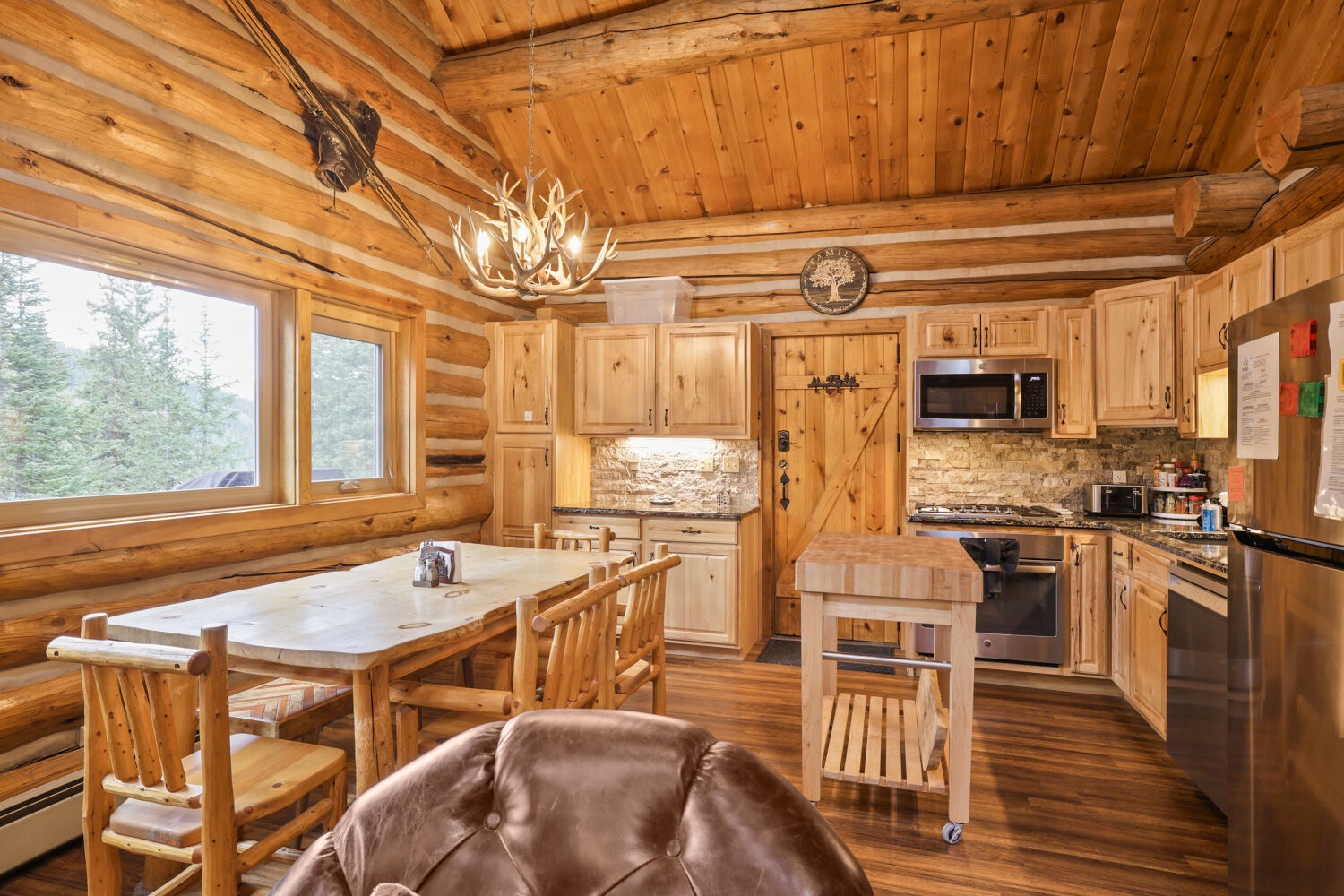 Step into your cozy mountain retreat, where rustic wood beams and natural light create the perfect escape. The fully-equipped kitchen and open dining area invite you to gather and make yourself at home in this warm, handcrafted space.