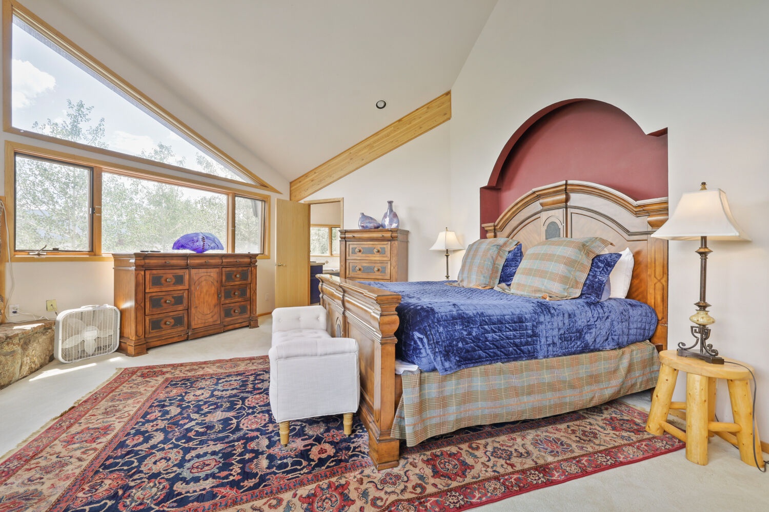 Unwind in your sunlit bedroom, where vaulted ceilings and warm wood accents invite peaceful mountain mornings and restful nights.
