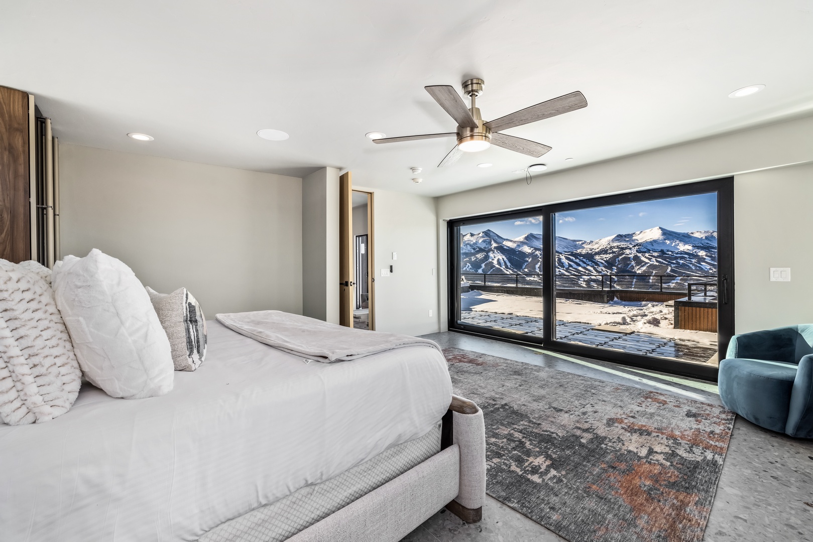 Wake up to breathtaking mountain views from your luxurious bedroom, where modern comfort meets stunning alpine scenery through floor-to-ceiling windows.