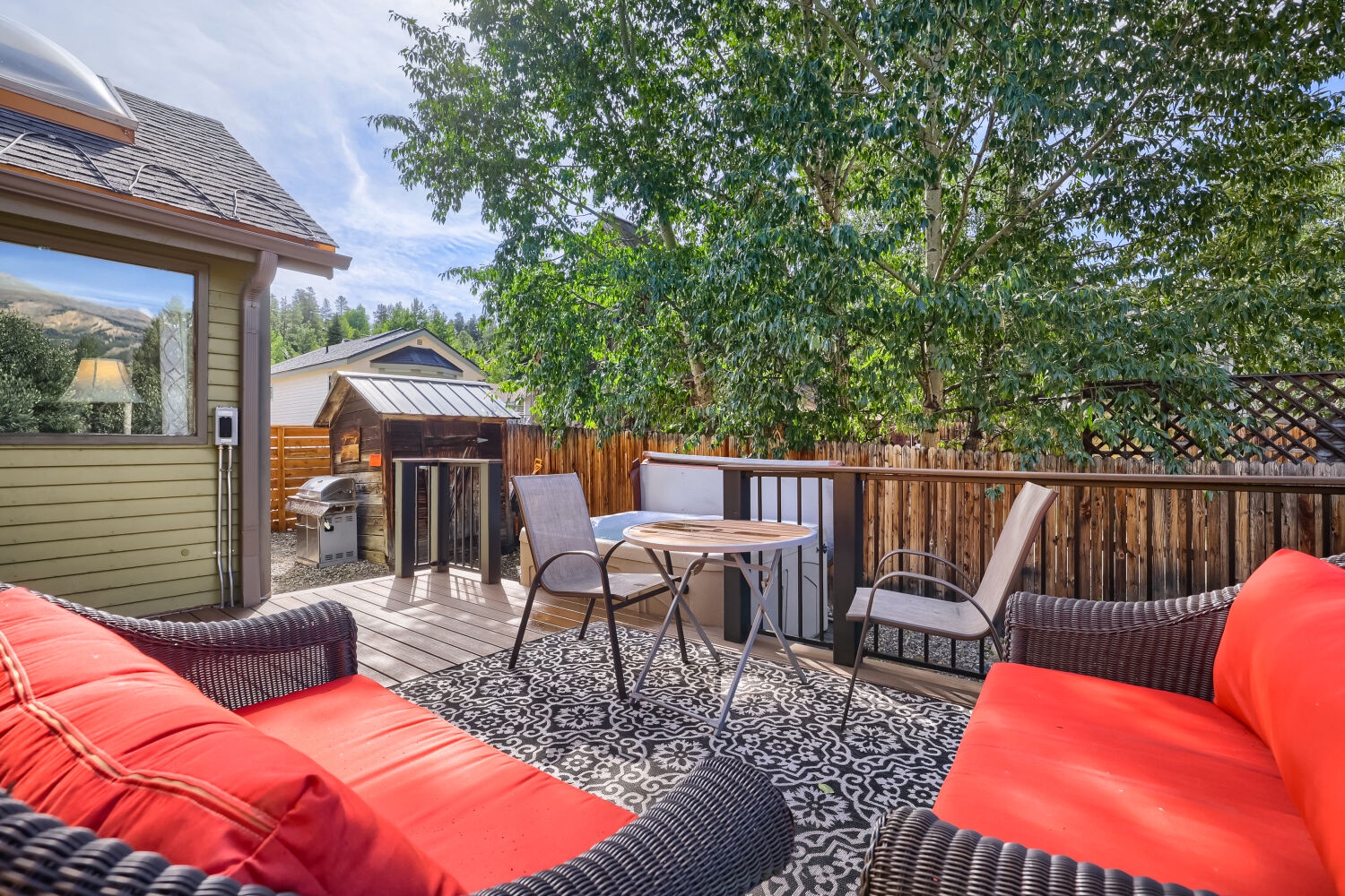 Sink into vibrant outdoor seating and unwind beneath leafy shade. Your private deck offers a peaceful retreat for morning coffee or evening gatherings under the open sky.