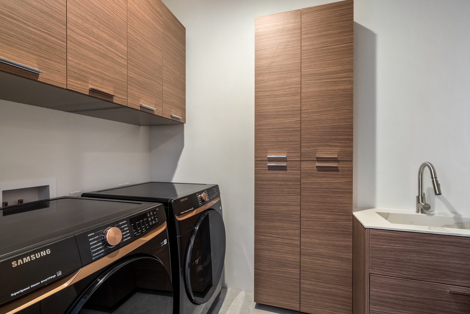 Step into your private laundry space with sleek Samsung appliances and ample storage to keep your vacation wardrobe fresh.