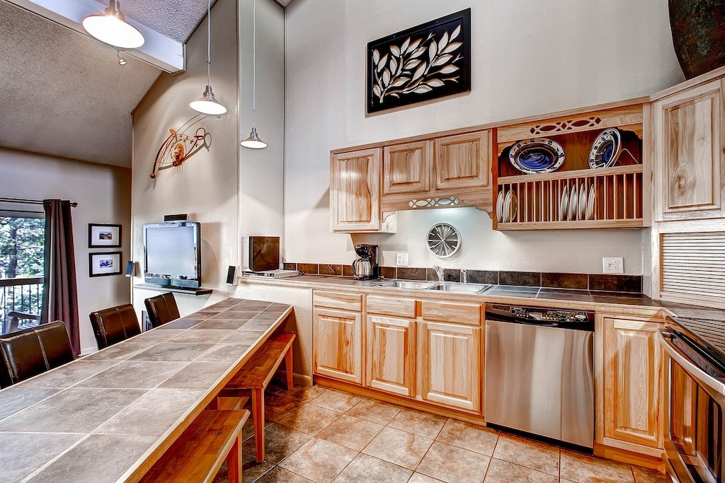 Your spacious kitchen welcomes you with warm wood cabinets, stainless steel appliances, and a generous dining table perfect for memorable meals.