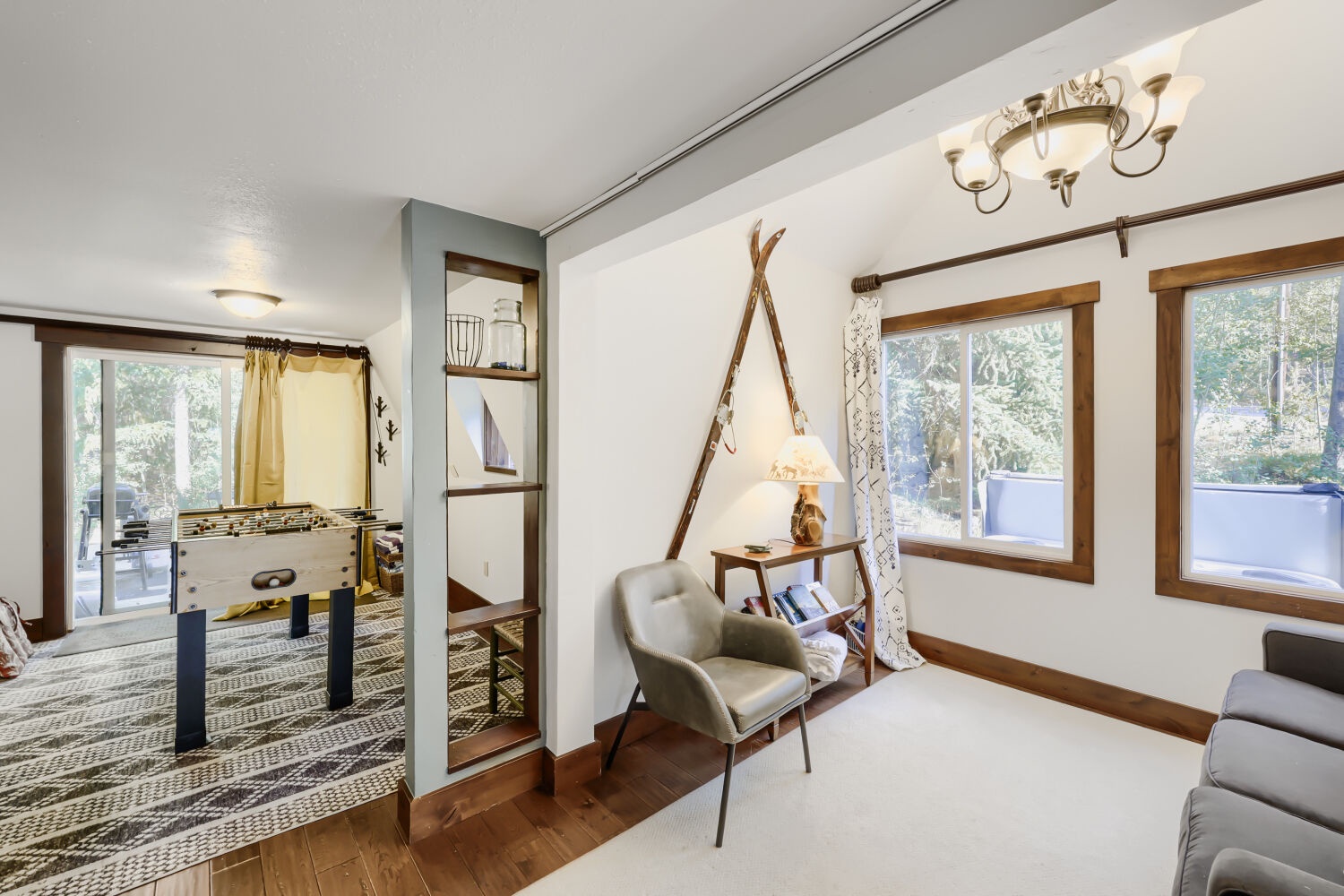 Step into your charming retreat where natural light pours through large windows, illuminating a thoughtfully designed living space. The cozy reading nook and open layout create the perfect atmosphere for unwinding after your adventures.