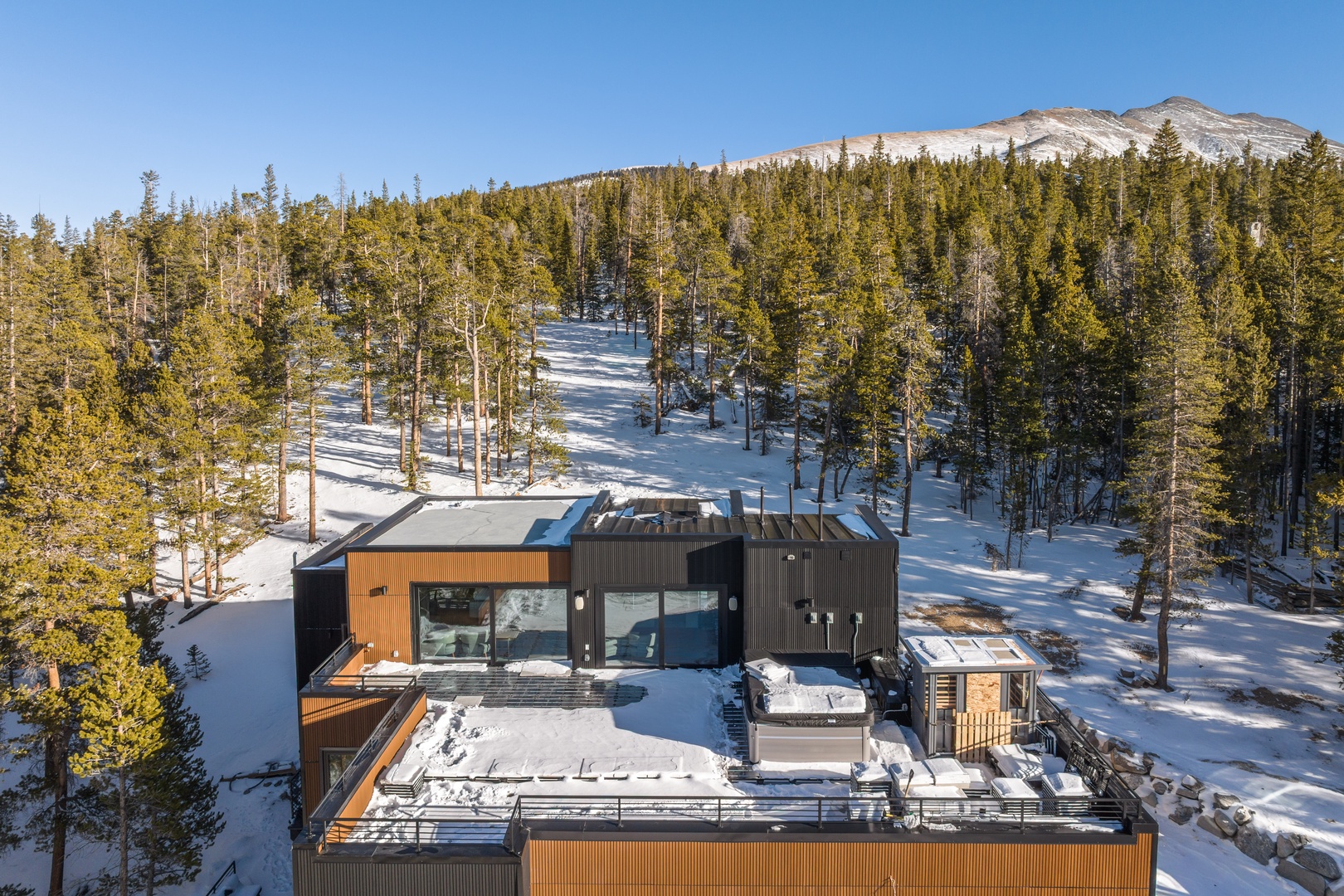 Mountain retreat surrounded by pristine wilderness and snow-covered peaks, offering complete privacy in nature's embrace.