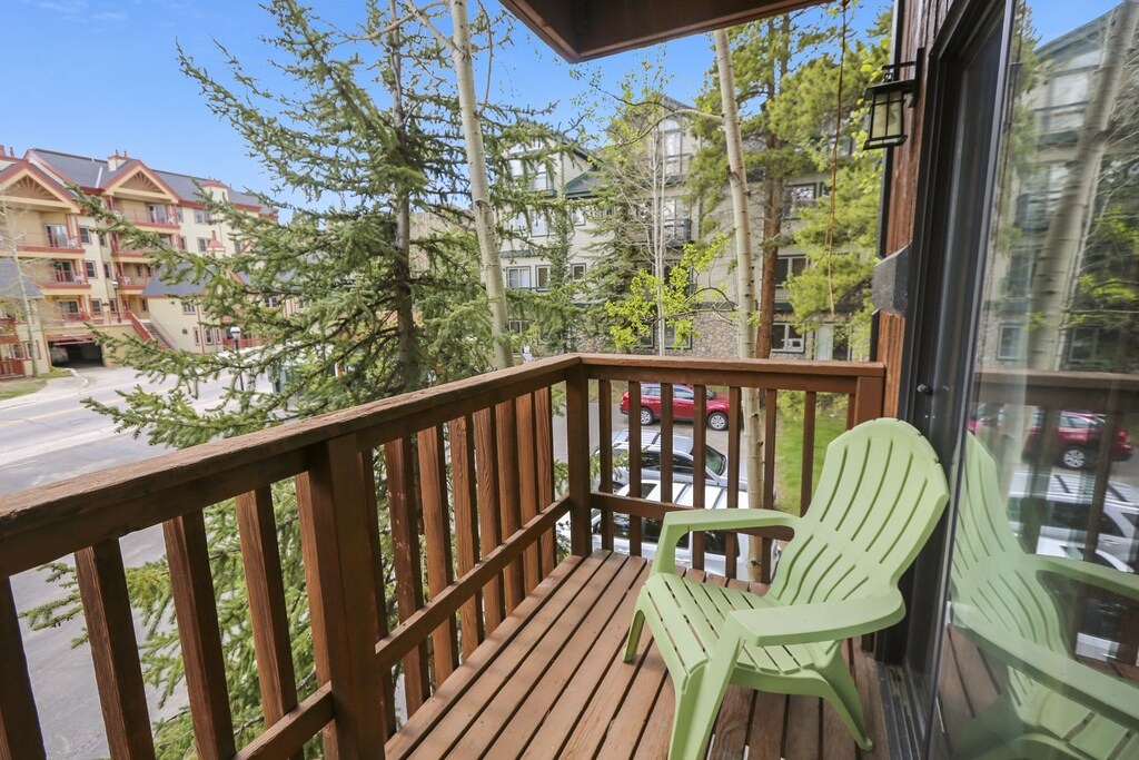 Step onto your private balcony and enjoy peaceful tree-lined neighborhood views from comfortable outdoor seating.