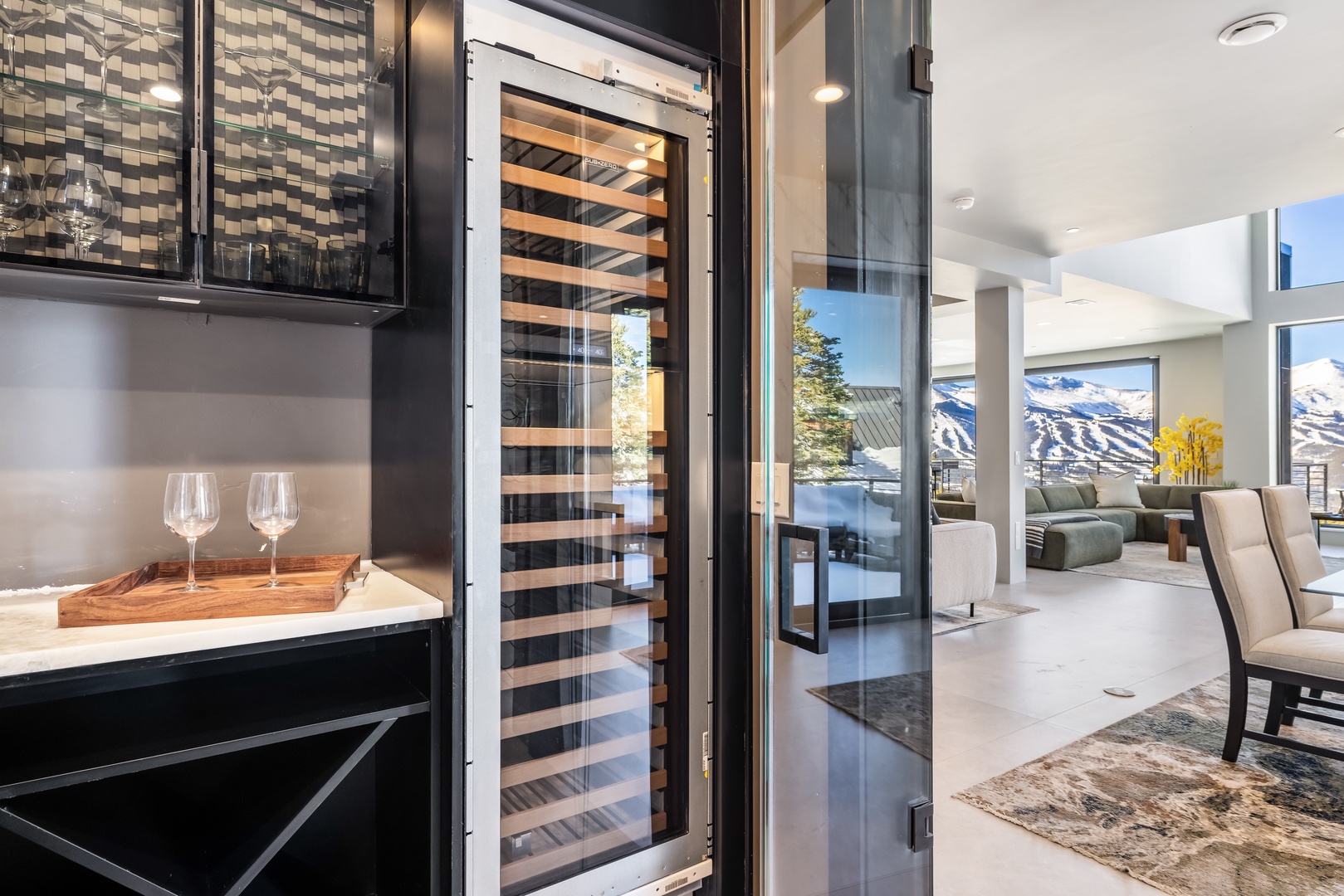 Your sophisticated wine fridge keeps bottles perfectly chilled while you sip and savor panoramic mountain views from this elegant kitchen and living space.