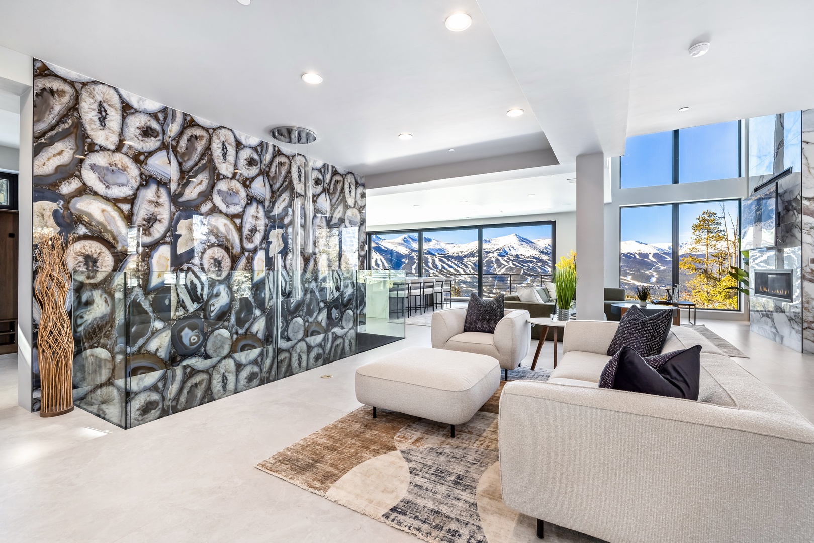 Unwind in your stunning living space where modern design meets breathtaking mountain views through floor-to-ceiling windows.