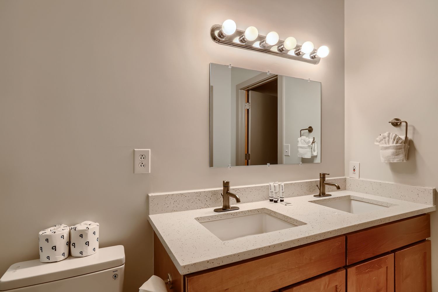 Step into your bright bathroom with dual vanities, perfect lighting, and thoughtful amenities to start your morning refreshed.