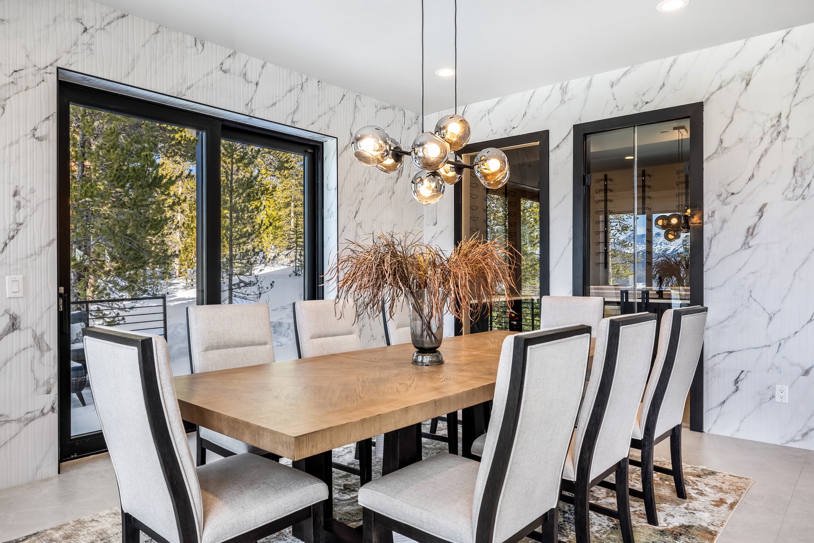 Gather around your elegant dining table beneath stunning marble walls and designer lighting for memorable meals.