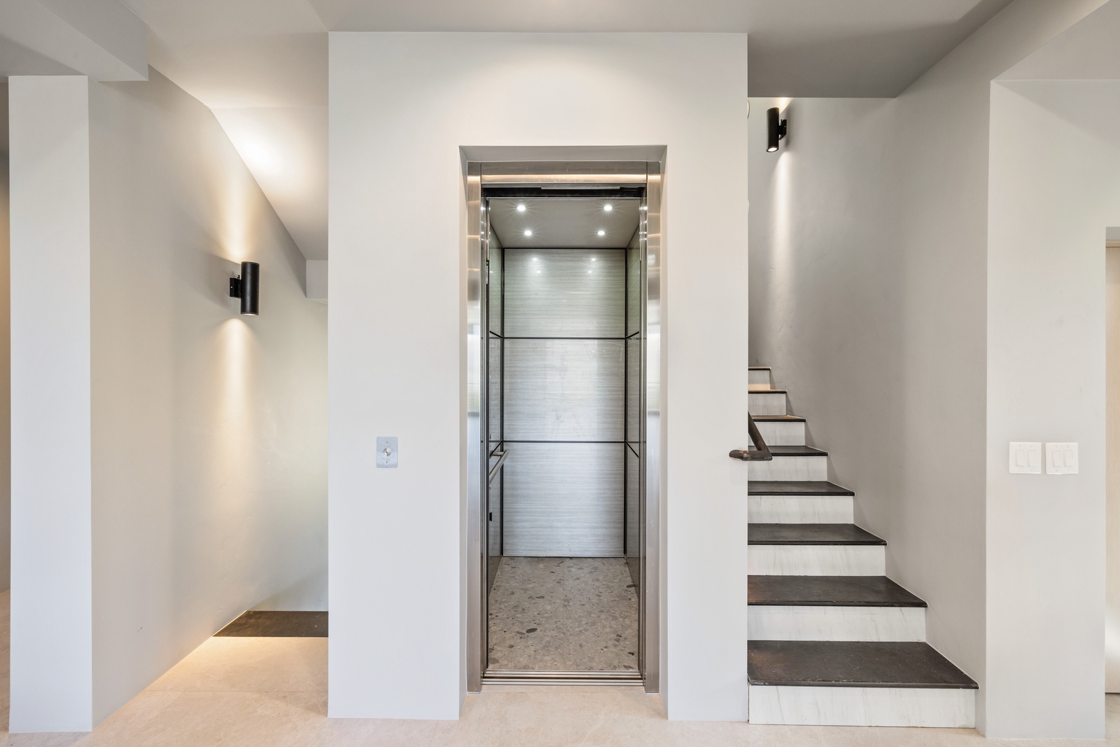 Step into your modern retreat where sleek design meets convenience - the elevator ensures effortless access to every floor of your stylish getaway.