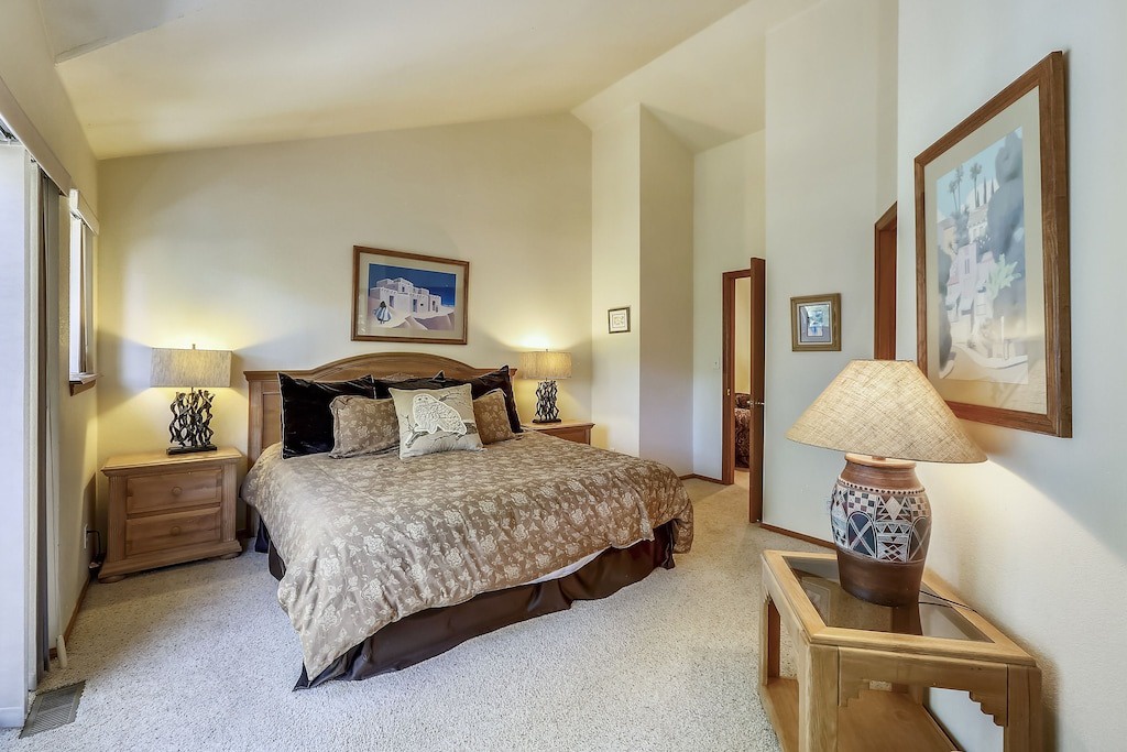 Sink into plush bedding and warm lighting in your private retreat, where thoughtful artwork and cozy furnishings create the perfect sanctuary.