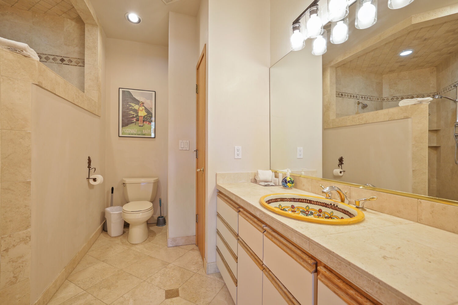 Step into your private bathroom, where bright vanity lighting and a beautifully handcrafted ceramic sink make every morning feel special. The spacious layout invites you to refresh and unwind in comfort.