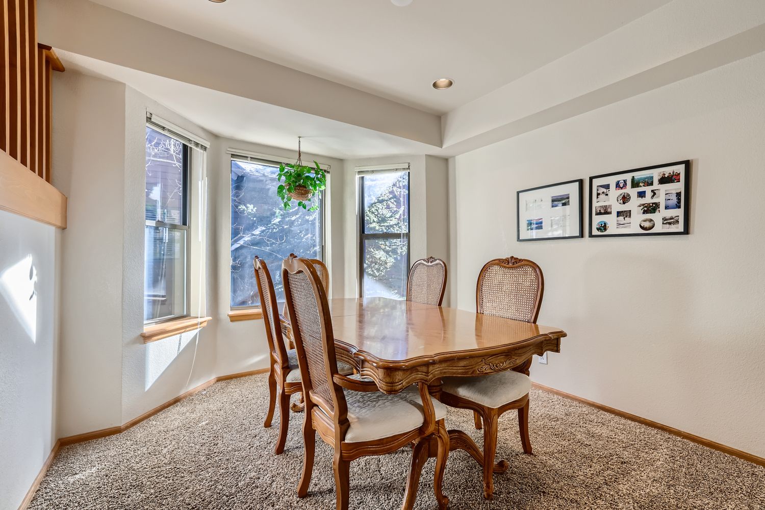 Gather around this elegant dining table where natural light streams through windows, creating the perfect setting for memorable meals with family and friends.