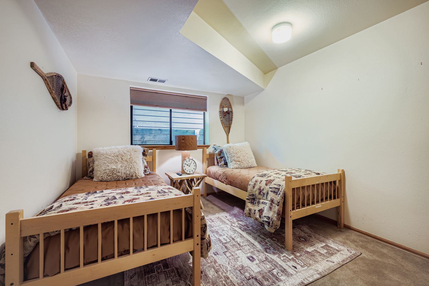 Your cozy twin bedroom features comfortable wooden beds with plush bedding, perfect for restful nights after exploring the area.