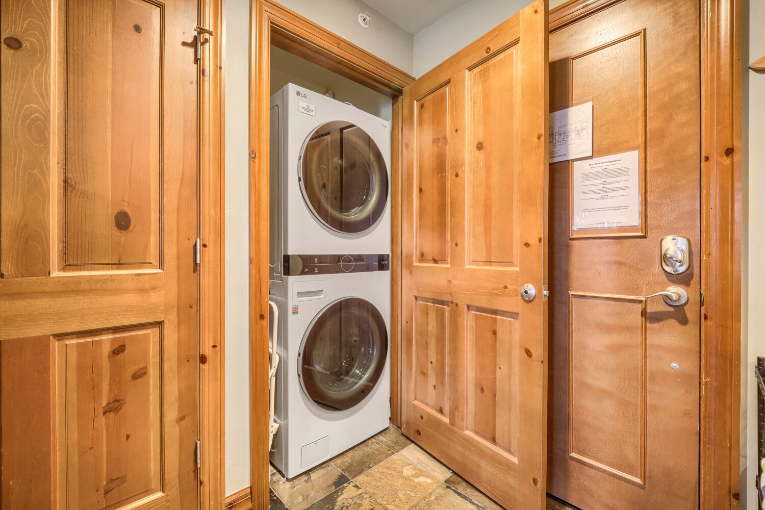 Tuck away your gear and freshen up effortlessly with your own in-unit washer and dryer, neatly housed behind warm wooden cabinetry for a seamless stay.