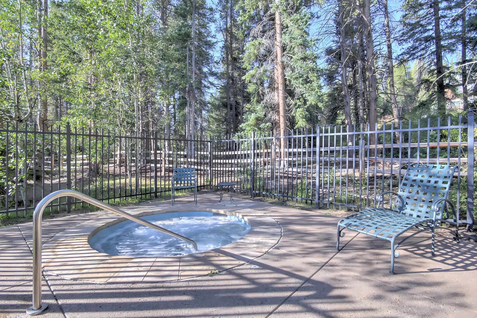 Soak your cares away in this private hot tub surrounded by towering pines, where forest tranquility meets pure relaxation.