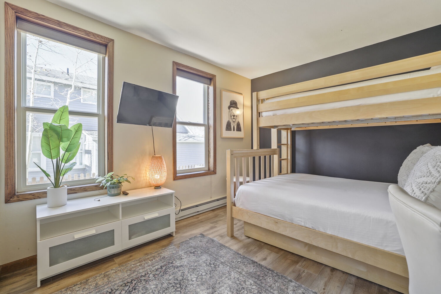 Your cozy retreat features a bunk bed and peaceful street views, blending modern style with thoughtful design. Relax beneath soft natural light, surrounded by warm wood tones and stylish decor that make this space feel like home.