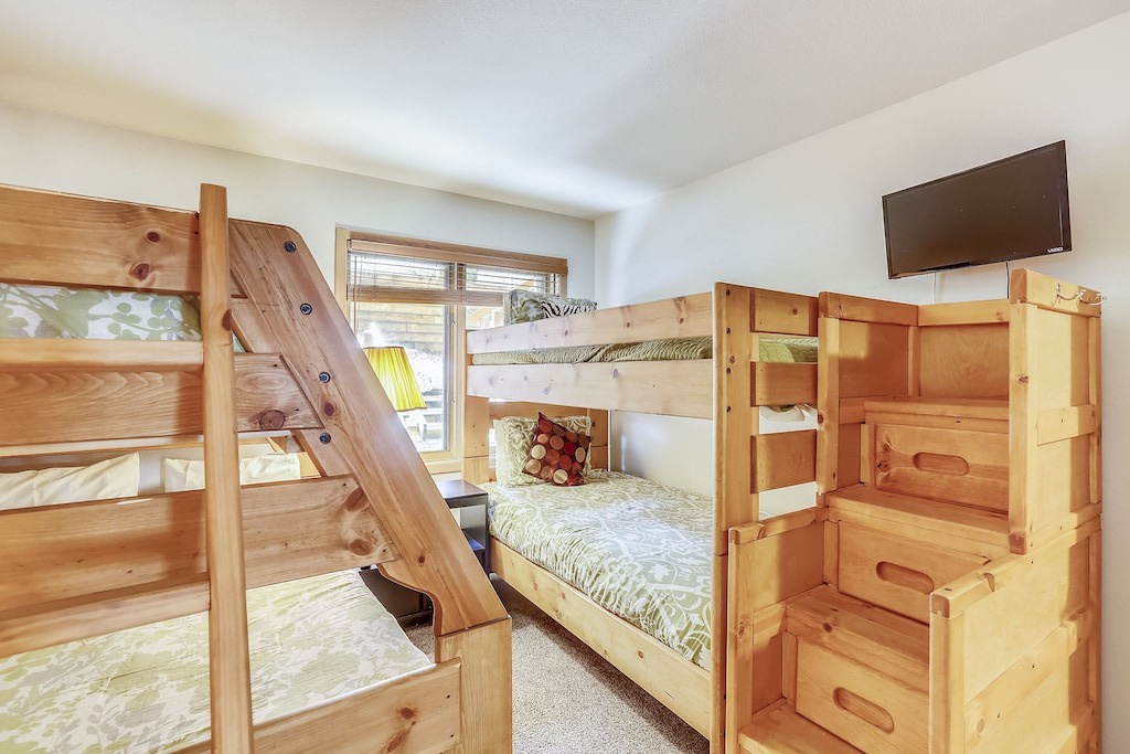 Sleep soundly in your cozy bunk room featuring sturdy wood beds, soft linens, and entertainment on demand.