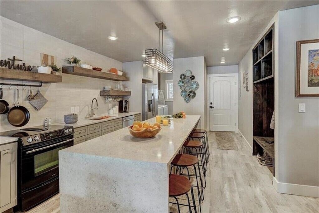 Gather around the spacious island in your fully-equipped kitchen, where marble countertops and rustic charm create the perfect cooking sanctuary.
