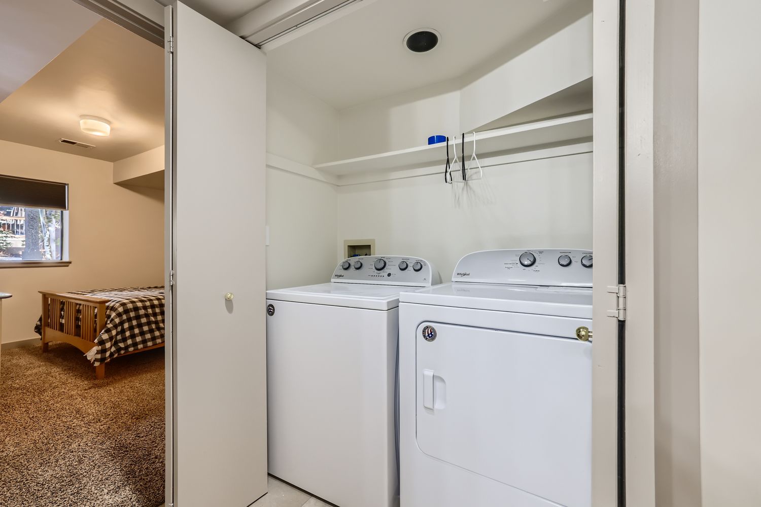 Your private washer and dryer make extended stays effortless, tucked conveniently in this clean, organized laundry space.