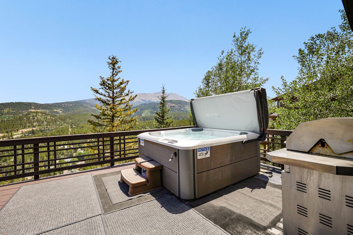 A private hot tub on your deck with sweeping views of forested valleys and mountain peaks—perfect for soaking under open skies.