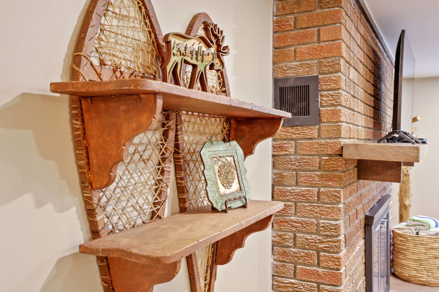 Rustic charm meets modern comfort—your cozy retreat features a beautiful brick fireplace and unique vintage snowshoe decor, perfect for warming up after a day of adventure.