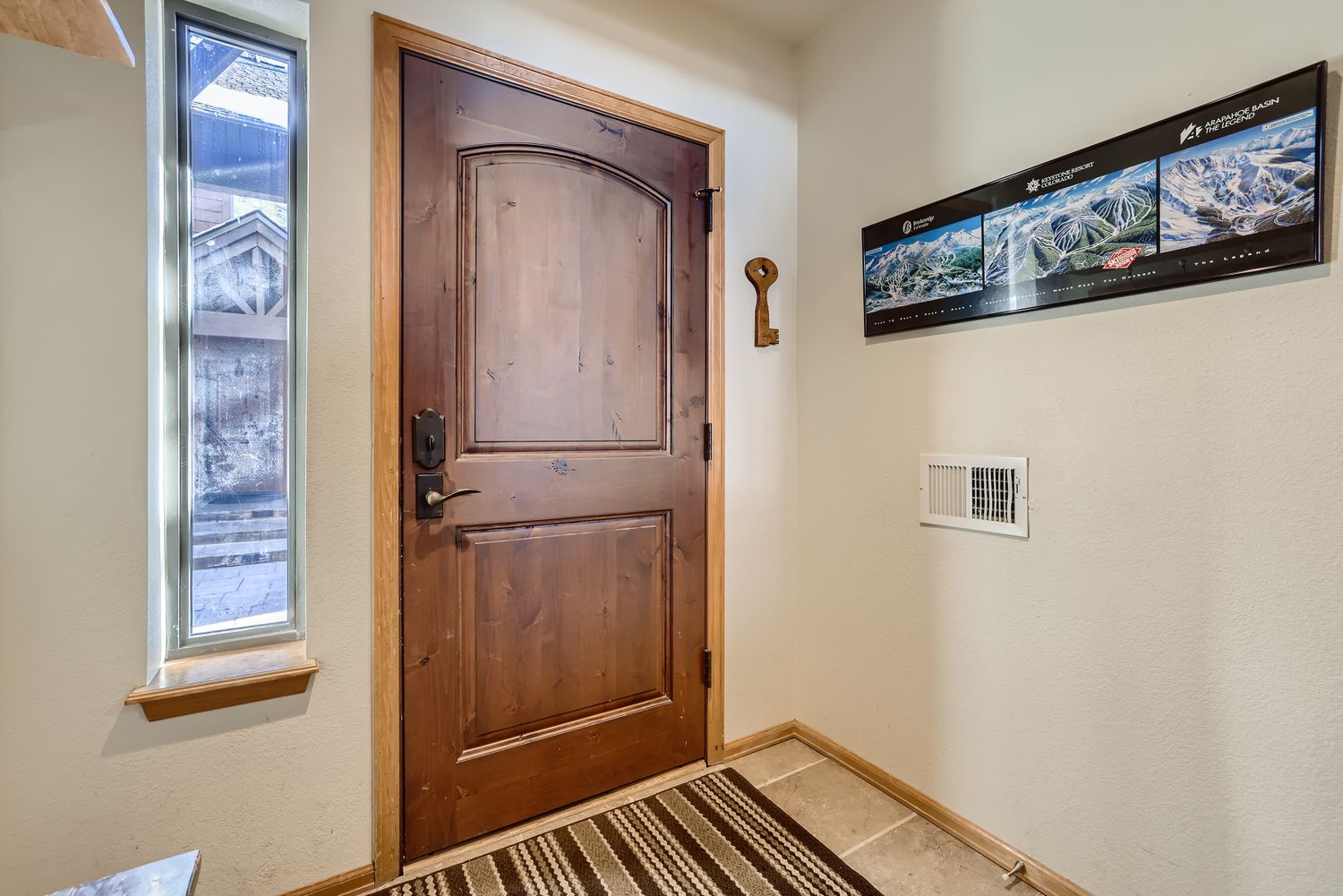 Step inside your cozy mountain retreat through this welcoming entry, where rustic charm meets modern comfort in your home away from home.