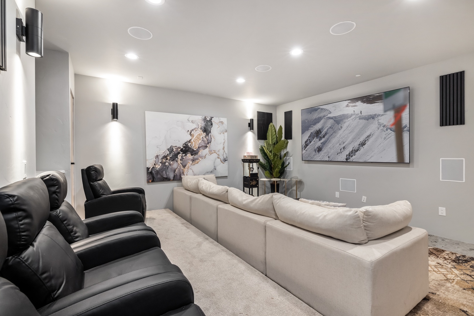 Sink into plush theater seating and enjoy movie nights in your private cinema room with surround sound and elegant modern design.