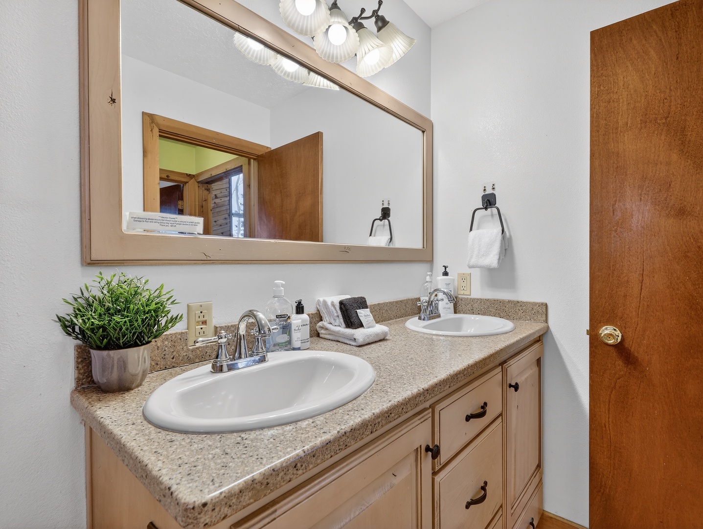 Enjoy the luxury of dual sinks with granite countertops and ample storage in your beautifully appointed bathroom.
