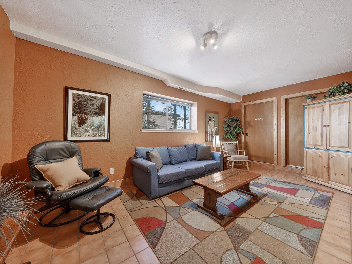 Unwind in this cozy living room where warm earth tones and comfortable seating create your perfect retreat for relaxation.