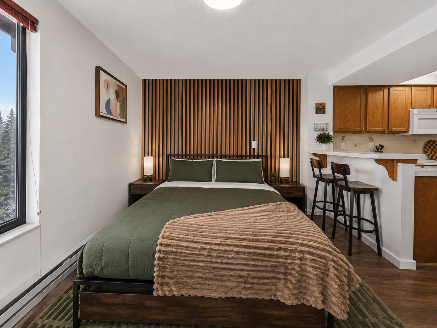 Sink into the plush bedding and wake to mountain views from your window. The open-concept space features a full kitchen and breakfast bar, perfect for cozy mornings in.