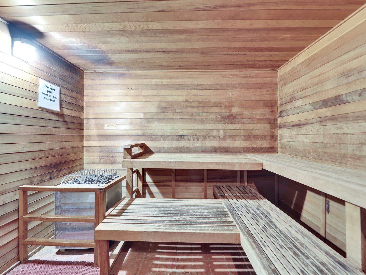This authentic wooden sauna features tiered benches and heated stones, perfect for unwinding after a day of exploring.