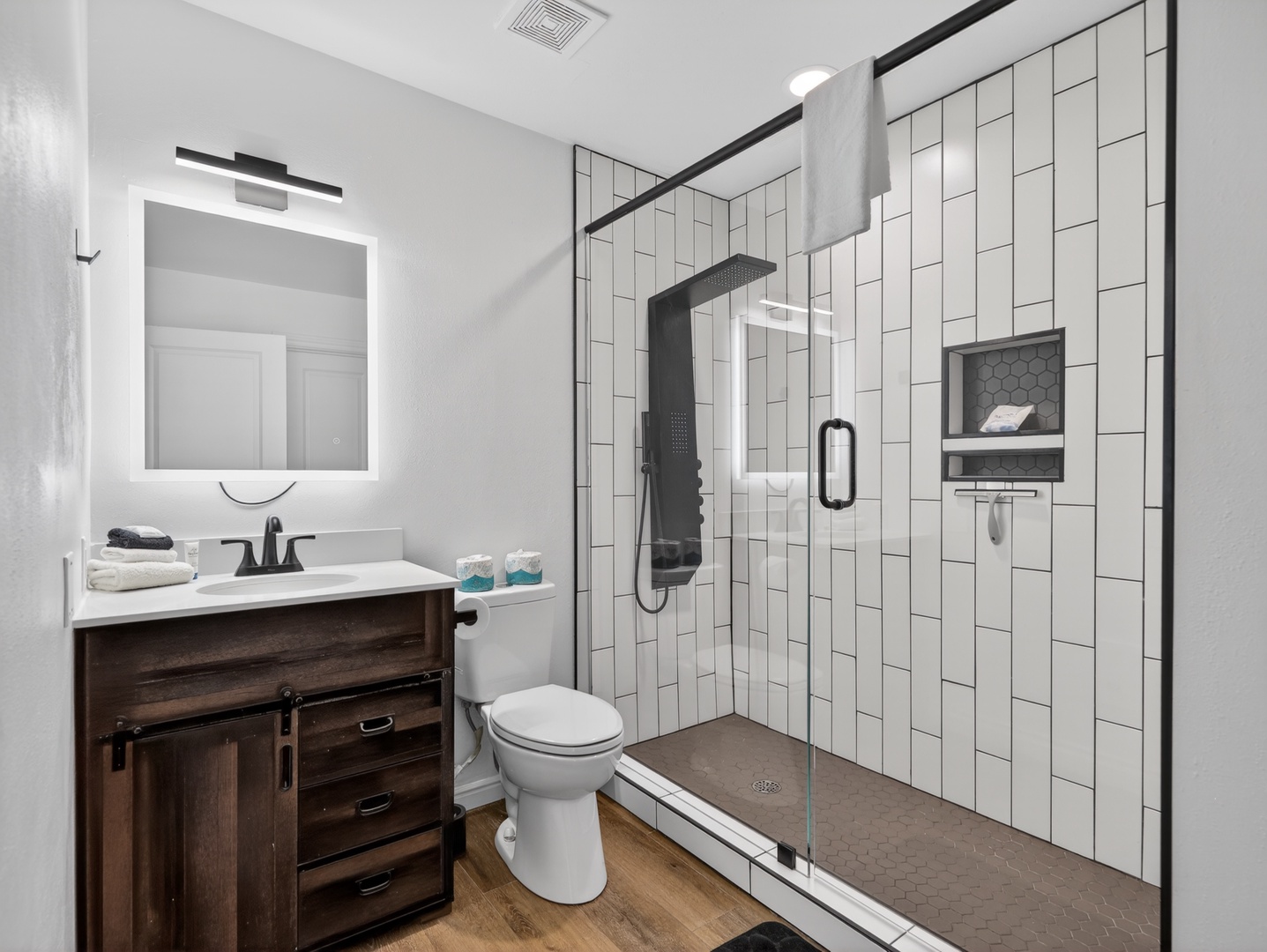 Modern bathroom with walk-in glass shower and clean, updated finishes