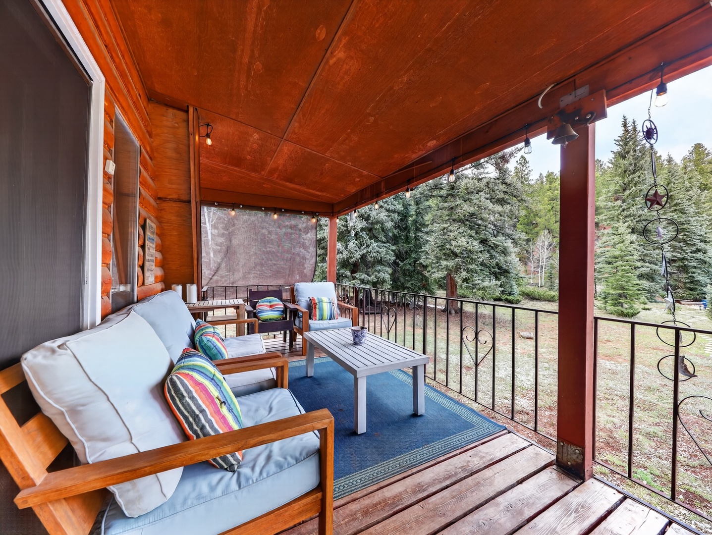 Covered deck surrounded by trees—perfect for morning coffee or evening unwinding