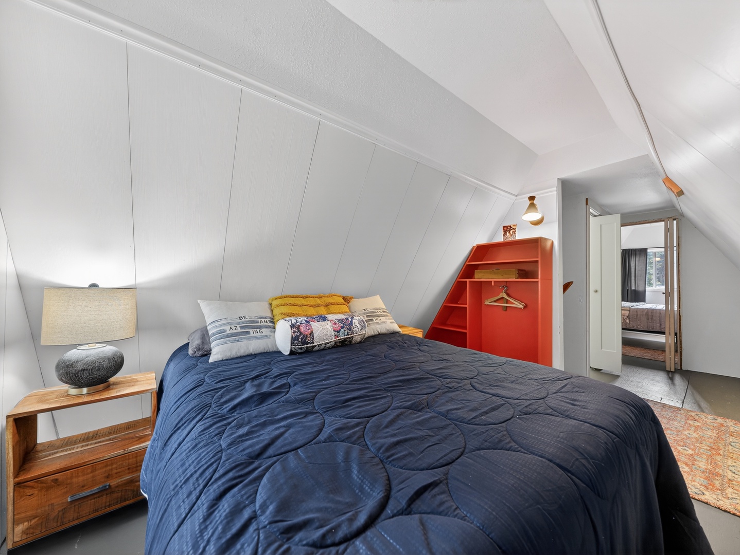 Inviting guest bedroom with warm cabin touches and queen bed