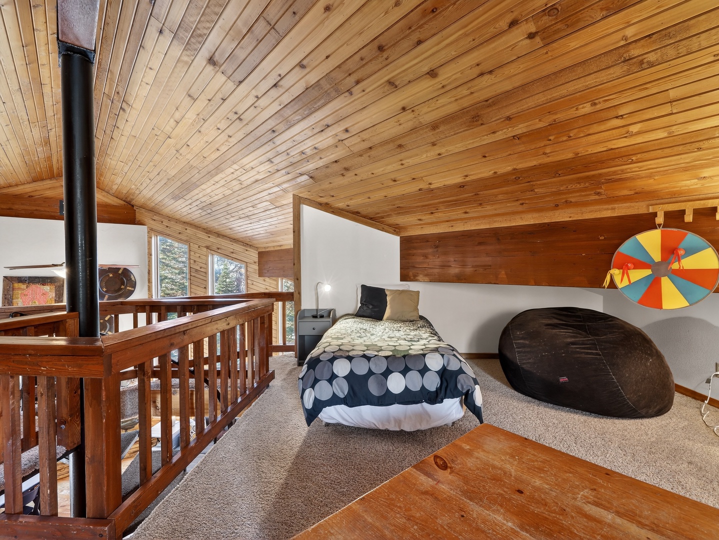 Your cozy loft bedroom features warm wood beams, comfortable bedding, and unique character touches that make you feel right at home.