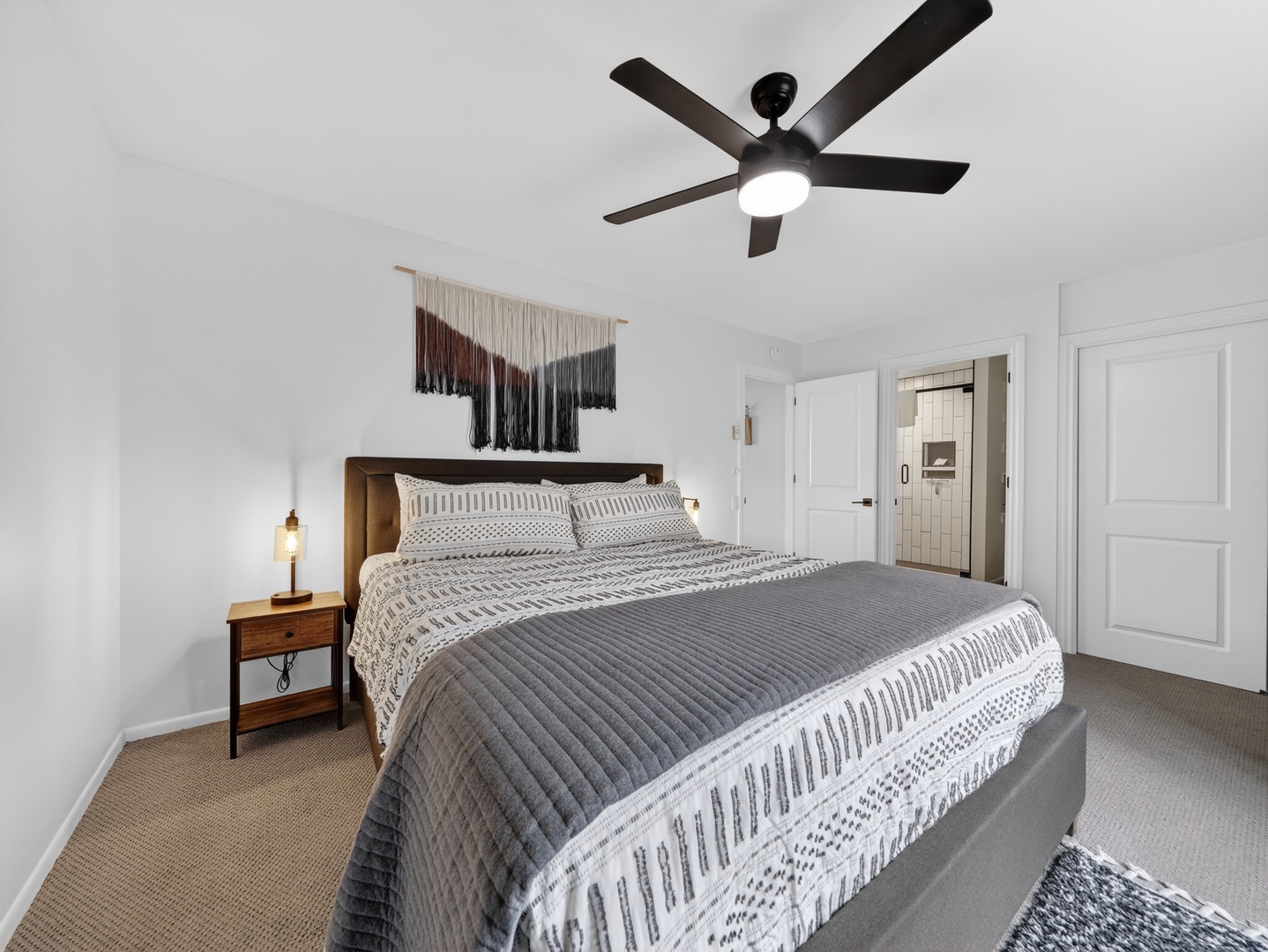 Primary bedroom with plush king bed and calming, modern mountain touches