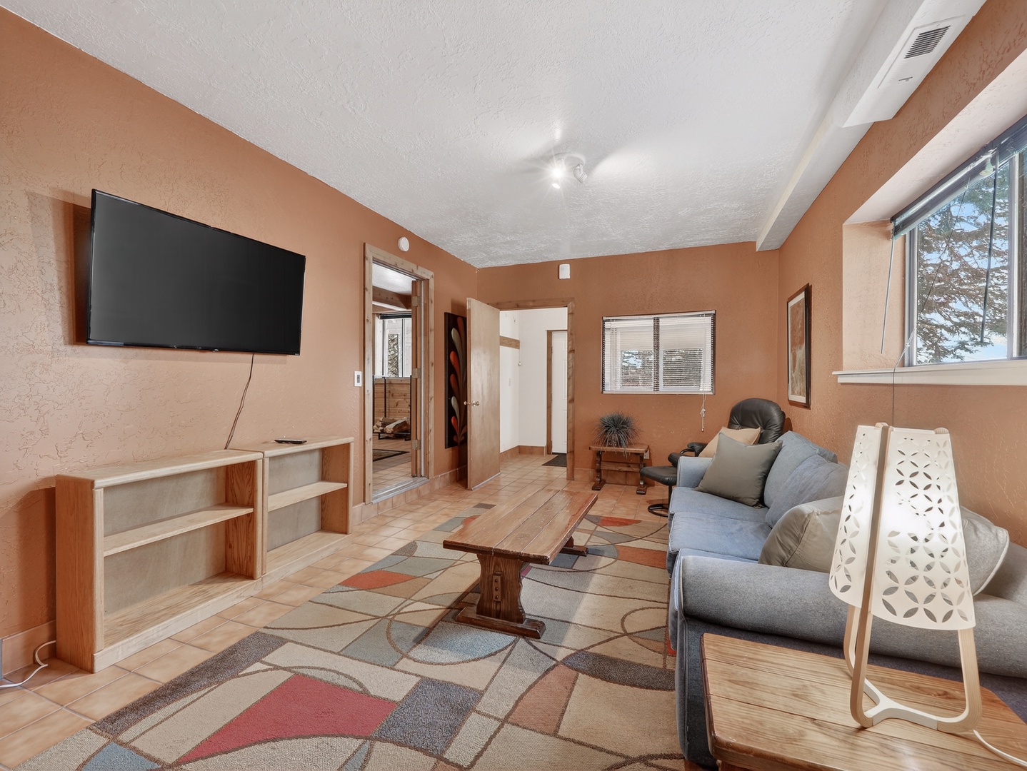 Settle into your comfortable living room with warm earth tones, modern furnishings, and entertainment ready for relaxing evenings.