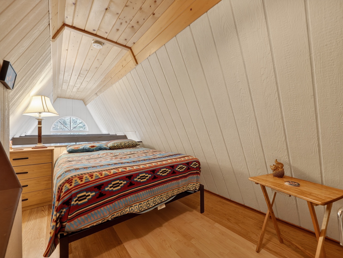 Charming loft-style sleeping space with classic A-frame character
