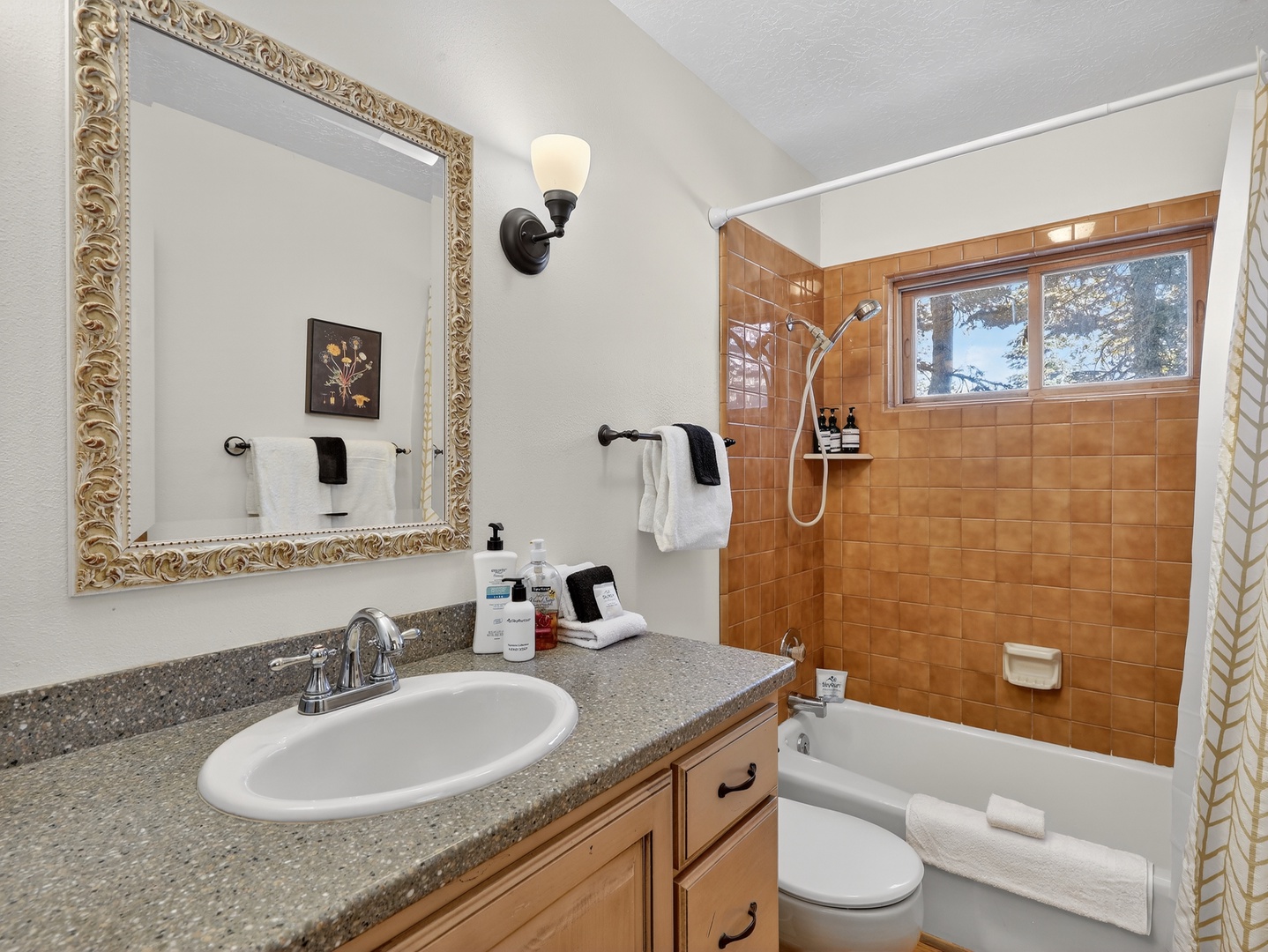 Your private bathroom features warm tile details, granite counters, and everything you need to refresh after mountain adventures.