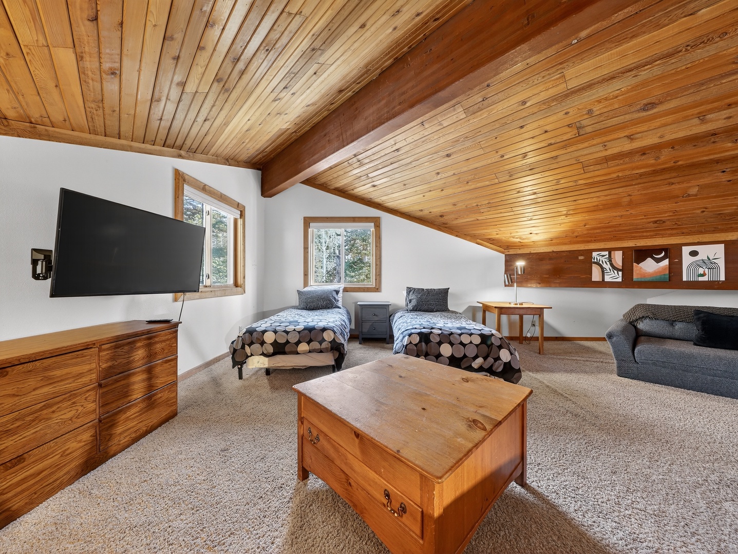 Your cozy loft retreat features twin beds, warm wood beams, and mountain views - perfect for unwinding after adventures.