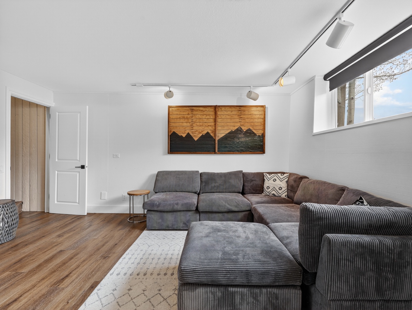Spacious lower-level living area with TV and comfortable seating