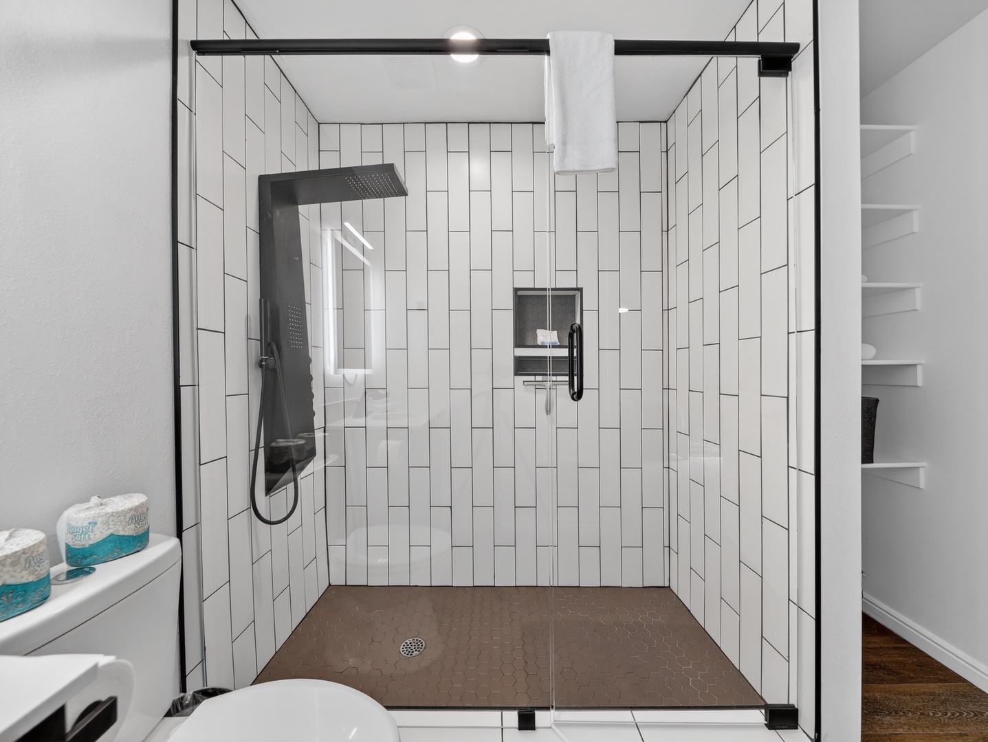 Modern bathroom with walk-in glass shower and clean, updated finishes