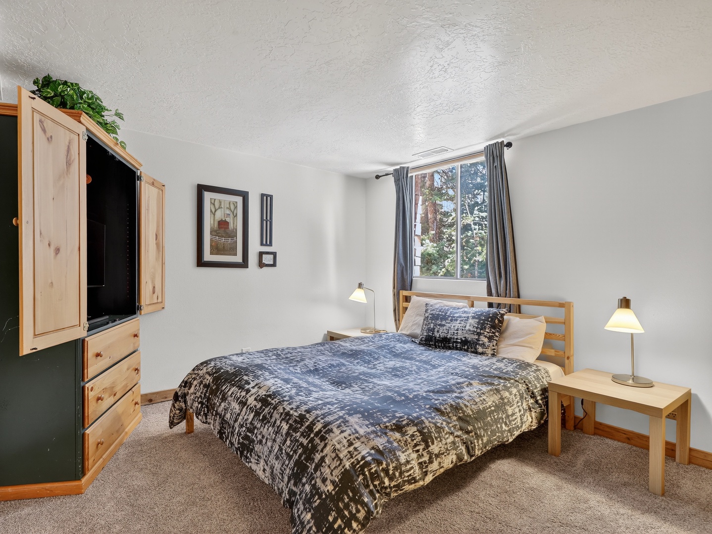 Unwind in your cozy bedroom with natural light streaming through large windows and peaceful tree views to lull you to sleep.