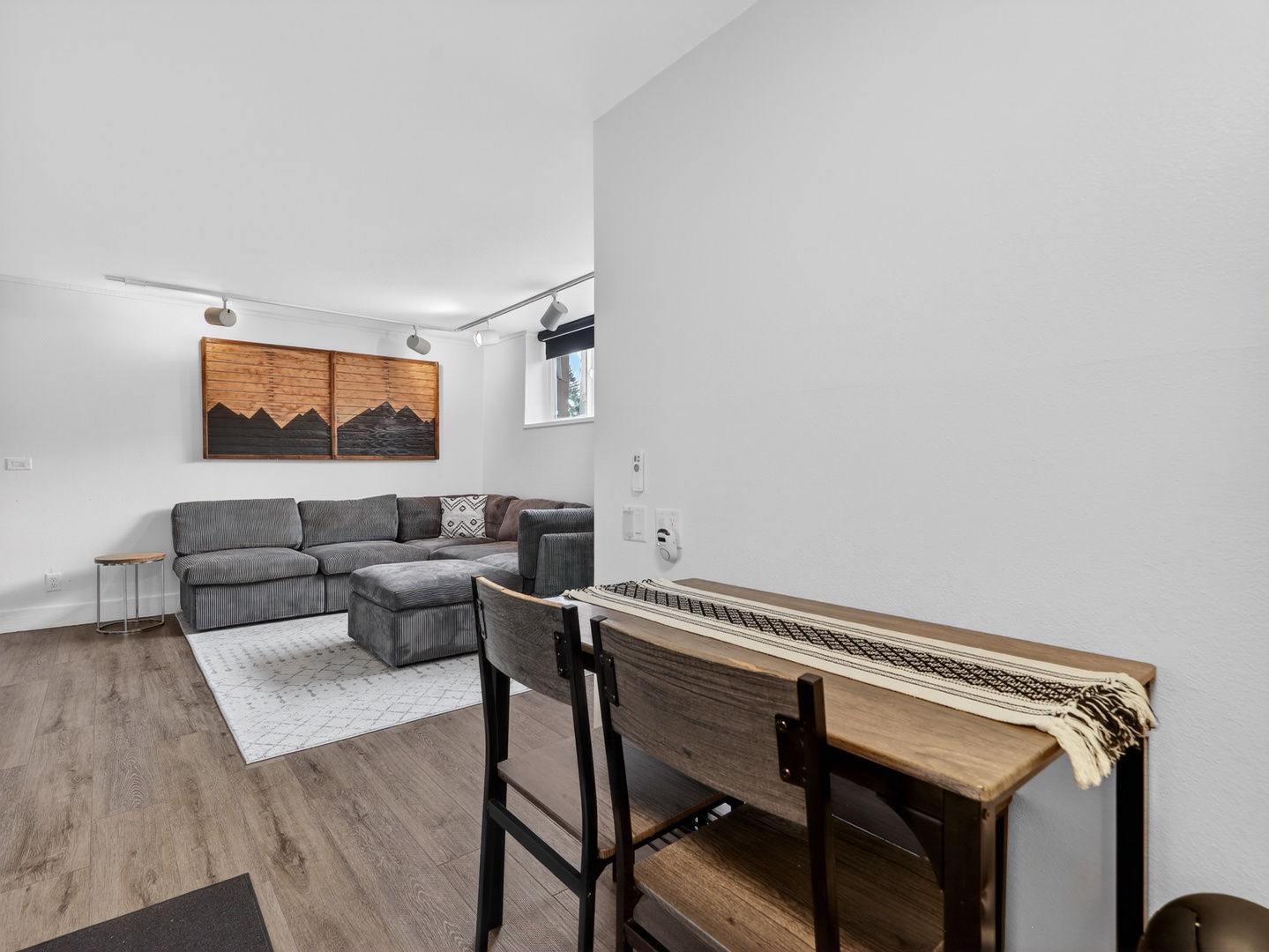 Spacious lower-level living area with TV, comfortable seating and eating area