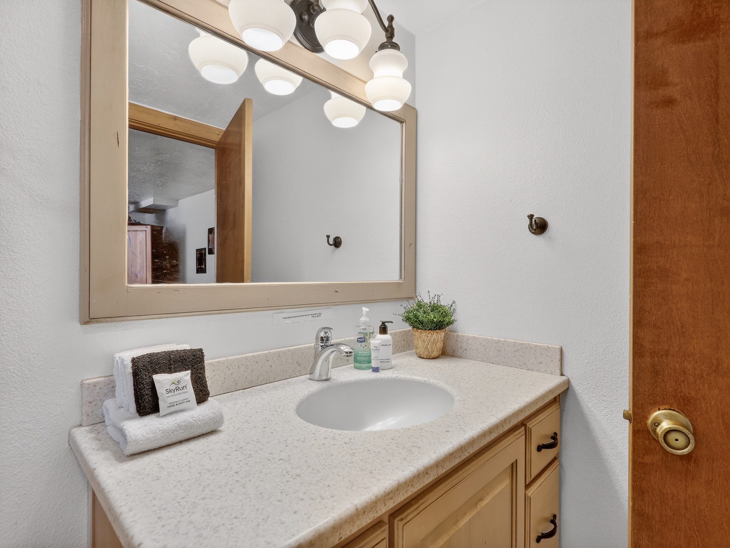 Step into your private bathroom featuring a spacious vanity, perfect lighting, and thoughtful amenities for a refreshing start to your day.