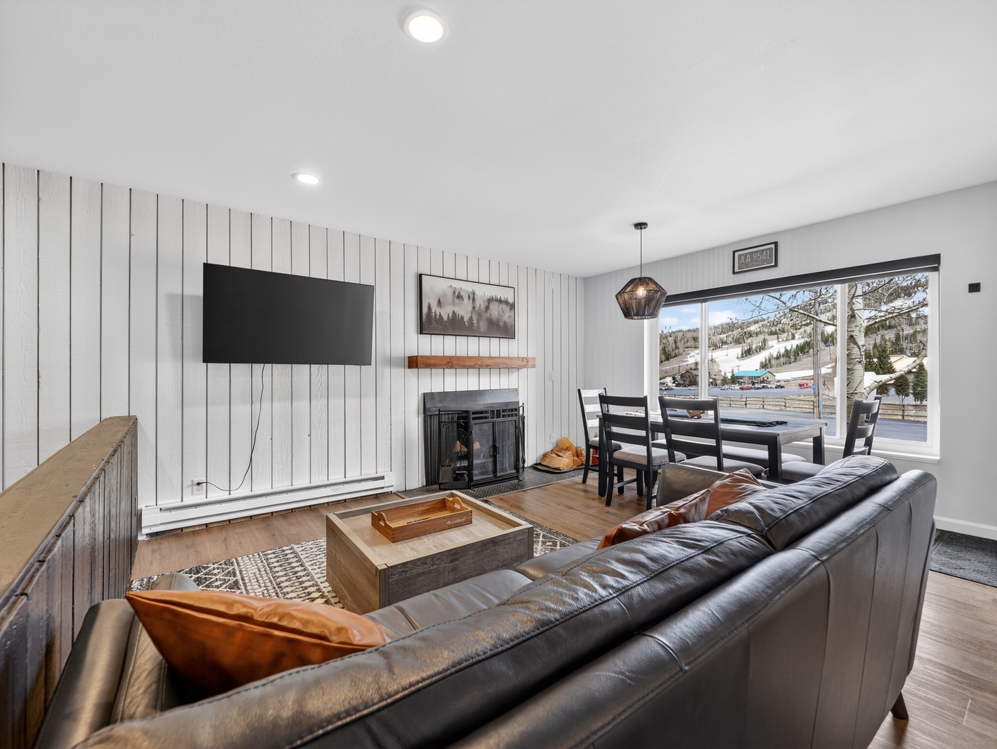 Sink into plush leather seating by the warm fireplace, catch your favorite shows on the large TV, and dine with mountain views filling the bright windows—your cozy retreat awaits.